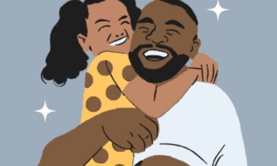 A joyful couple embraces and smiles together, showing warmth and affection.