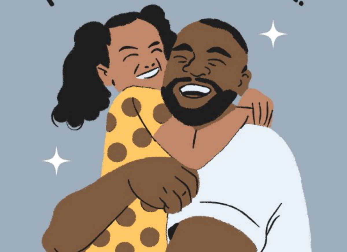 A joyful couple embraces and smiles together, showing warmth and affection.