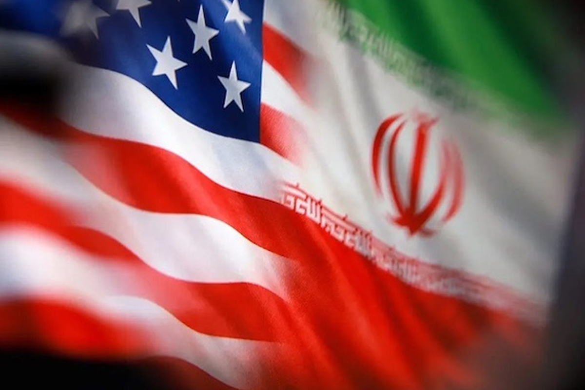 Close-up of a waving American flag blended with the Iranian flag, showing stars and red stripes.