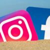 Instagram and Facebook logos partially buried in sand at the beach