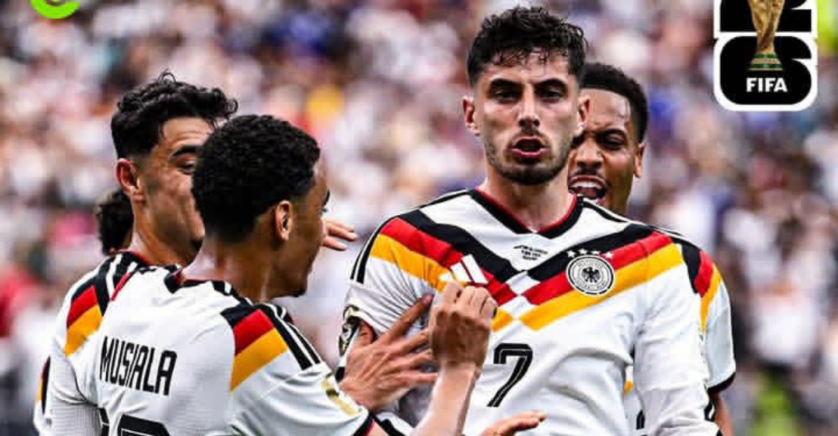 German national team players celebrate a goal, wearing white jerseys with black-red-gold stripes; Musiala visible on the back of one jersey.