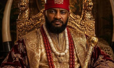 Portrait of a man in an ornate gold-embroidered robe wearing a red cap with a crest, seated on a gilded throne with a scepter and beaded jewelry.