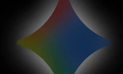 Colorful four-pointed diamond logo with a rainbow gradient against a dark vignette background.