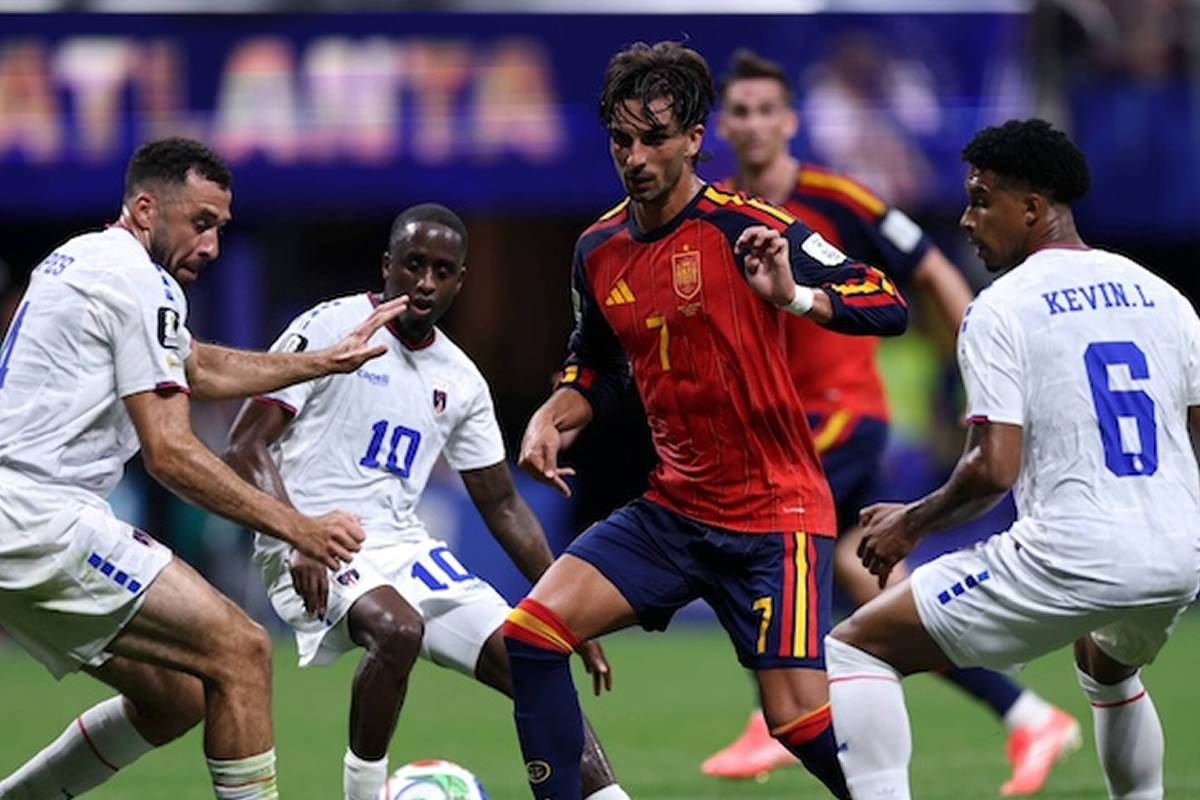 Soccer player in red jersey #7 dribbling the ball while four white-uniformed opponents close in on a green field.
