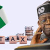 Nigeria tax concept: flag, stacked coins, and blocks spelling TAX beside a thoughtful elder man in traditional attire; conveys taxation in Nigeria.