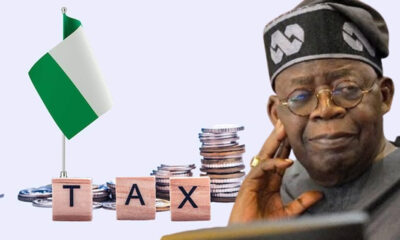 Nigeria tax concept: flag, stacked coins, and blocks spelling TAX beside a thoughtful elder man in traditional attire; conveys taxation in Nigeria.