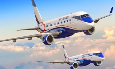 Two Air Peace passenger jets in white and blue livery flying above fluffy clouds in a clear sky.