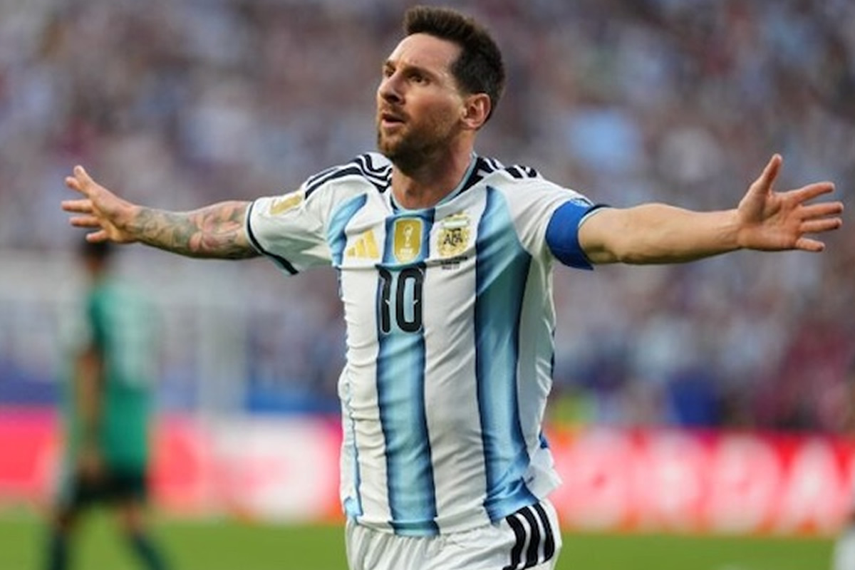 Argentine soccer player with arms outstretched celebrating on the field in a white and light-blue striped jersey with number 10, captain’s armband visible on the sleeve