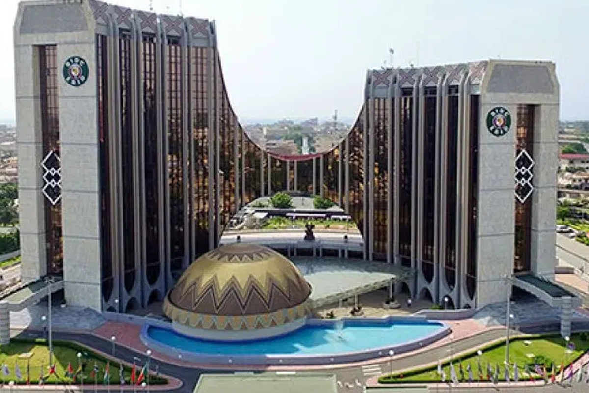 Large symmetrical government-style building with two tall wings, a central dome, and a curved reflecting pool in front.