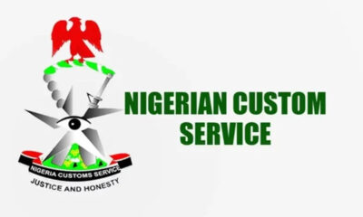 Logo for Nigerian Custom Service featuring a red eagle atop a green/white emblem, with the bold green title 'NIGERIAN CUSTOM SERVICE' and the motto 'JUSTICE AND HONESTY' beneath.