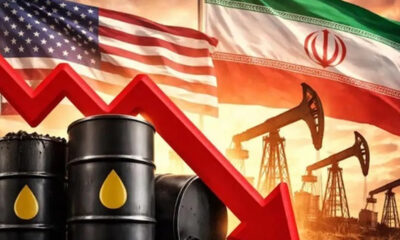 Oil barrels and rigs with a red downward arrow, set against U.S. and Iran flags, signaling falling oil prices.