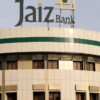 Jaiz Bank signage atop a modern beige building with a green stripe