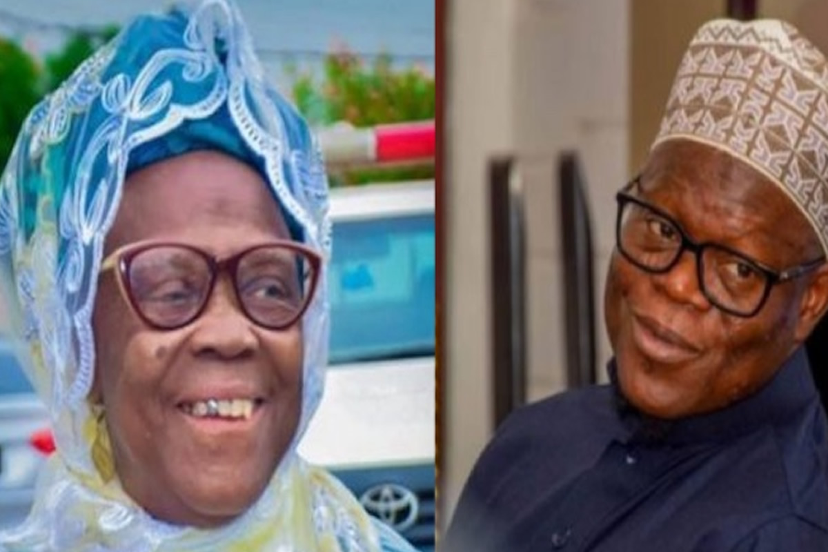 Smiling elderly woman in a blue lace headwrap and glasses (left) and an elderly man in a patterned kufi hat and dark shirt (right).