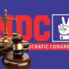 Scales of justice and judge's gavel in front of a red 'DC' logo and 'Democratic Congress' text on a blue background.