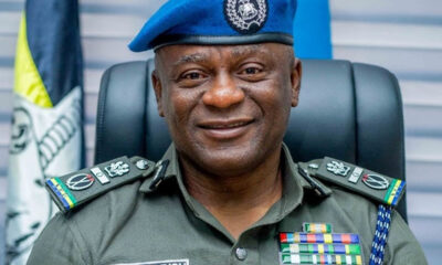 Colonel Olatunji Disu in a green dress uniform with ribbons and a blue beret, smiling at the camera.