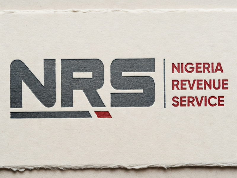 NRS logo: large dark gray letters 'NRS' with a small red diagonal accent, and 'NIGERIA REVENUE SERVICE' in red to the right
