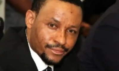 Close-up of a man in a suit smiling at the camera.