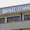Court of Appeal Abuja sign on a government building facade, with a small emblem on the left