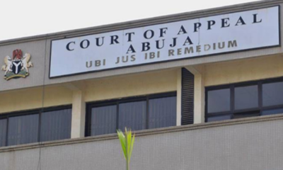 Court of Appeal Abuja sign on a government building facade, with a small emblem on the left