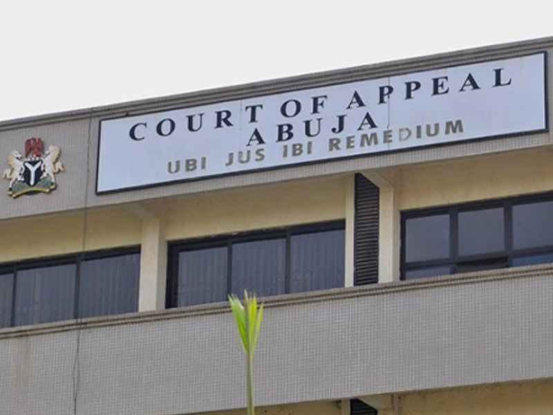 Court of Appeal Abuja sign on a government building facade, with a small emblem on the left