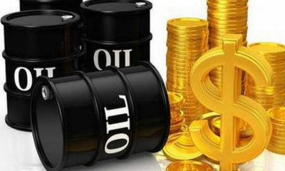 Black oil barrels labeled OIL beside stacks of gold coins and a large dollar sign, symbolizing oil profits.