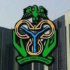 Facade of a tall bank building with the Central Bank of Nigeria logo prominently displayed