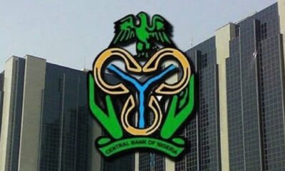 Facade of a tall bank building with the Central Bank of Nigeria logo prominently displayed
