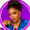 Glamour portrait of a woman with braided updo, bold makeup, wearing a blue blazer and large rings, inside a purple ring frame.