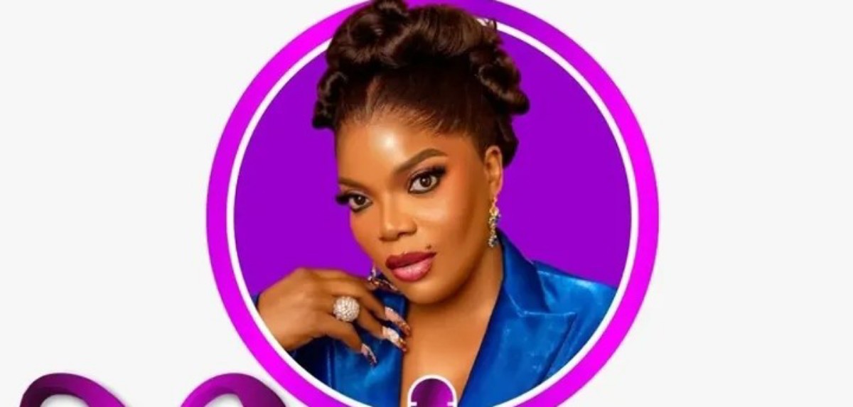 Glamour portrait of a woman with braided updo, bold makeup, wearing a blue blazer and large rings, inside a purple ring frame.