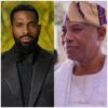 Two men side by side: left, a bearded man in a black textured suit and bow tie; right, a man in white traditional attire with a colorful headwrap, smiling.