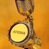 Golden microphone trophy with AFRIMA logo on the mic face against a gold background, close-up.