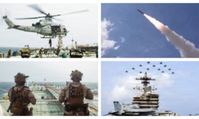 Navy helicopter hovering above a carrier deck with crew and equipment nearby.