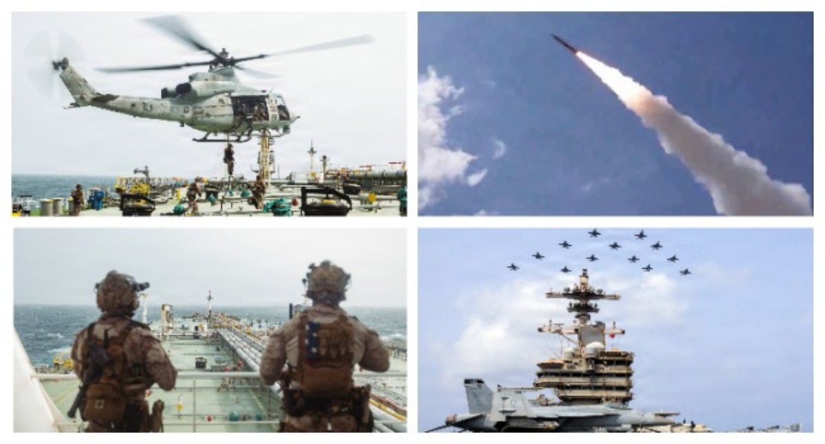 Navy helicopter hovering above a carrier deck with crew and equipment nearby.