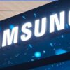 Samsung logo illuminated on a blue trade show banner/booth display at a tech event