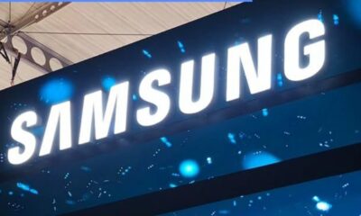 Samsung logo illuminated on a blue trade show banner/booth display at a tech event
