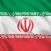 Iran national flag showing green, white, and red stripes with a red emblem in the center and Kufic script along the borders.