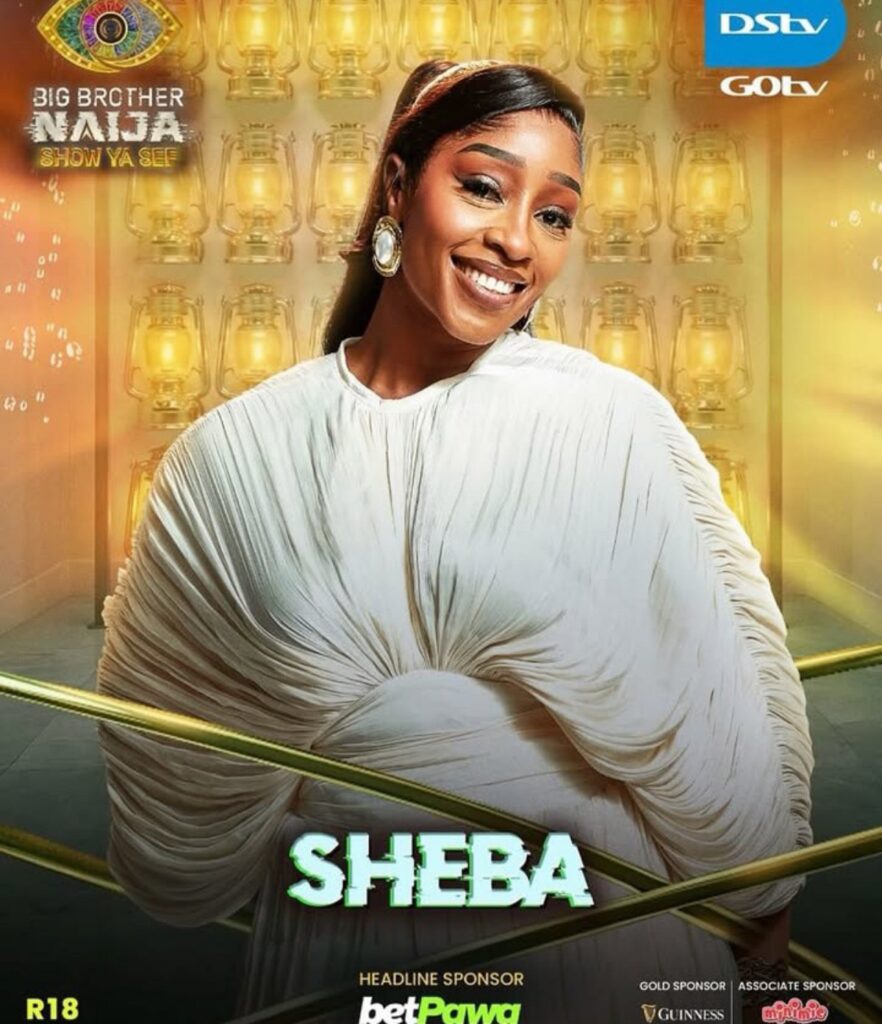 Promotional Big Brother Naija poster featuring a smiling Sheba in a white draped dress against a gold lantern backdrop, with sponsor logos nearby.