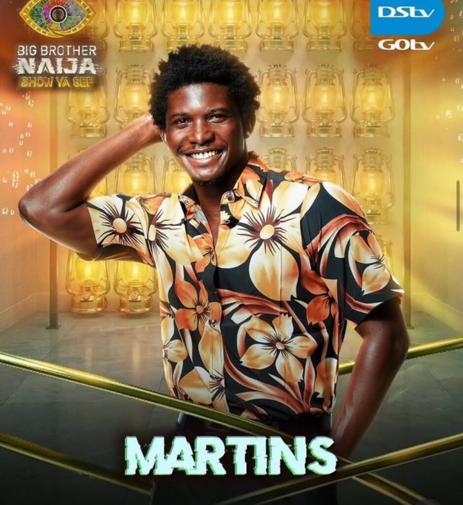 Martins, smiling man in a orange tropical shirt, posing in a gold-lit BBNaija promotional backdrop with show logos.