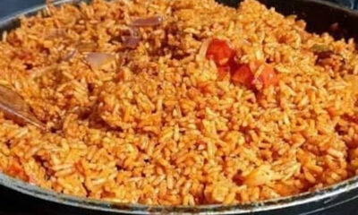 Pan of fried rice with visible orange hues and diced vegetables in a large skillet, ready to serve