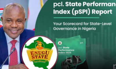 Man in a blue suit and red tie speaks at a podium, with the Enugu State logo and a green State Performance Index backdrop.