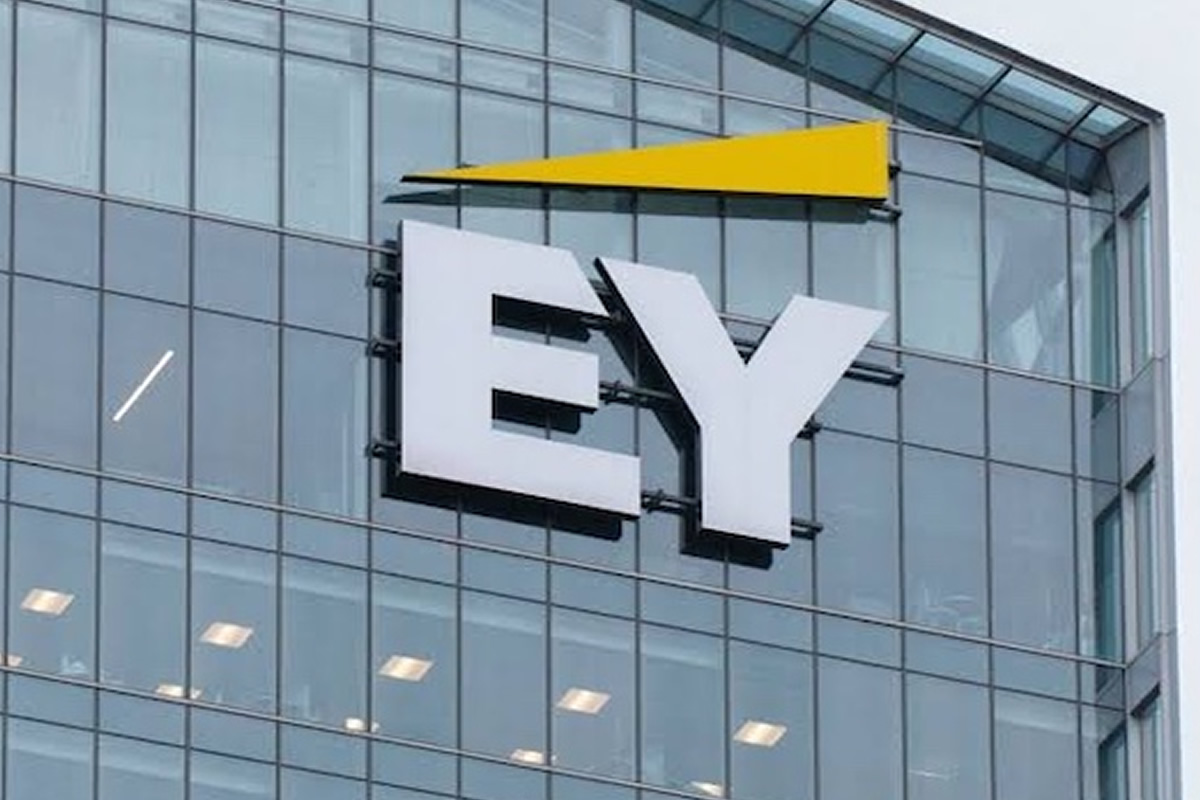 Glass-office building facade featuring a large white EY logo with a yellow triangular accent above.