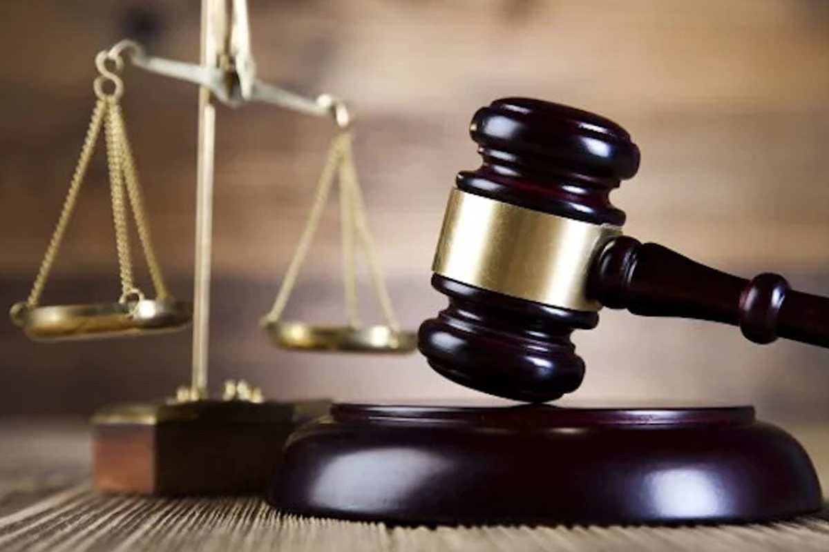 Gavel and scales of justice on a wooden surface, symbolizing law and court decisions