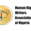 Logo for Human Rights Writers Association of Nigeria, showing Nigeria outline with a candle inside a yellow circle.