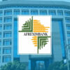 Afreximbank logo with green and orange geometric emblem on a blue office building background.