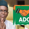 Man in white with a green cap, hands pressed in prayer; on the right is the ADC (African Democratic Congress) logo overlayed.