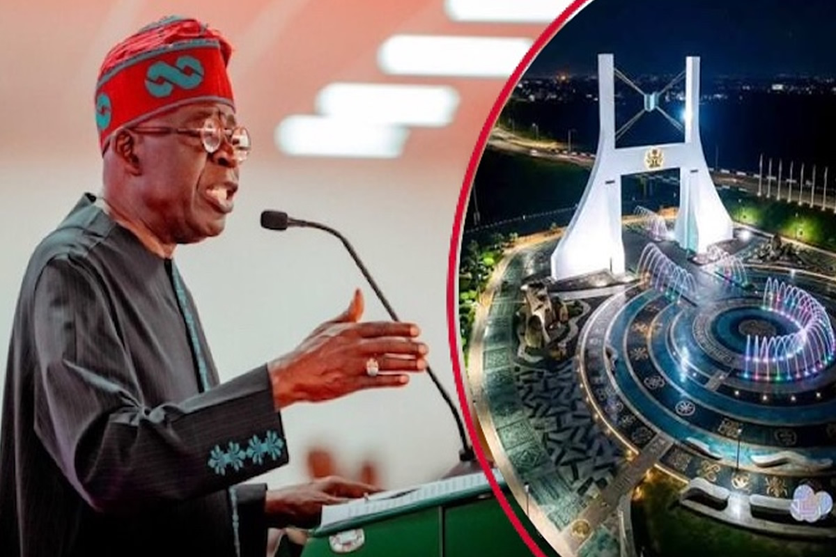 A man in traditional attire speaks at a podium, with a circular inset on the right showing a nighttime view of a futuristic white arch monument and illuminated surrounding plaza.