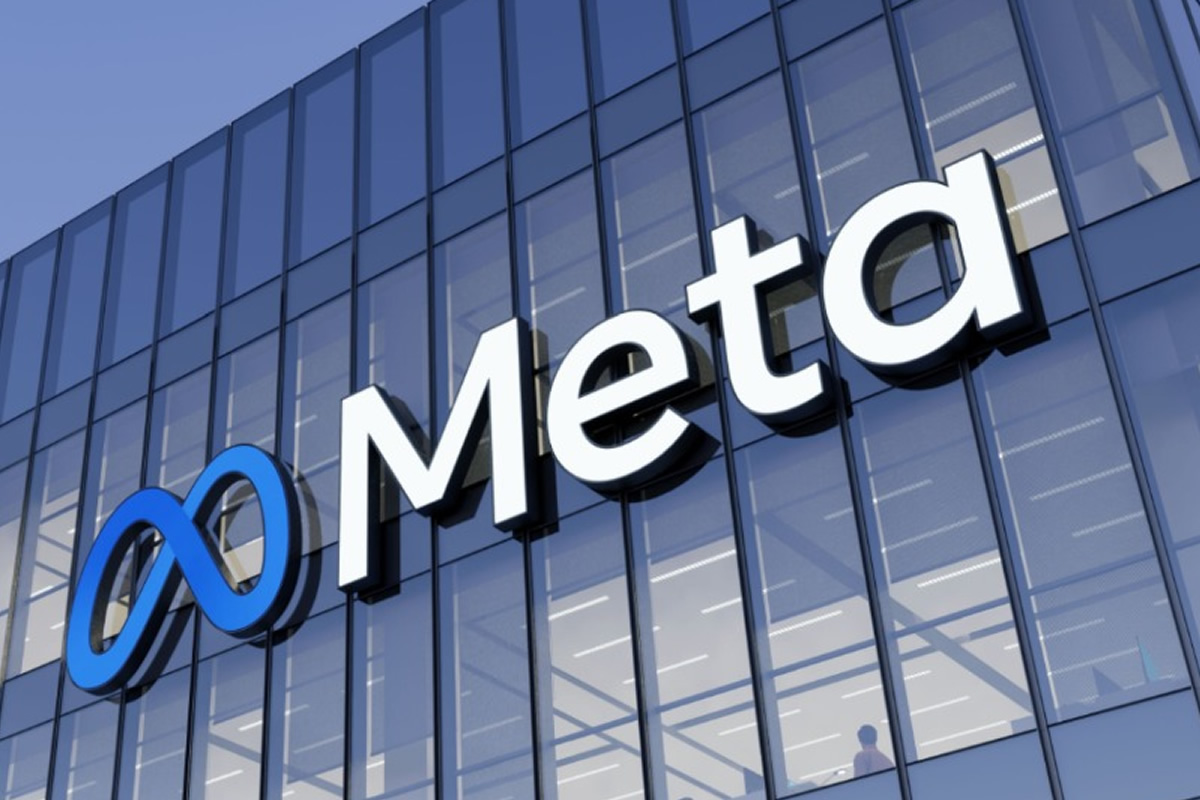 Meta logo with a blue infinity symbol and white letters on a glass office building facade against a blue sky