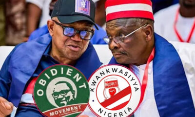 Two men at a political rally wearing round campaign badges for Obidient Movement and Kwankwasiyya Nigeria.
