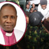 Portrait of a bishop in pink clerical attire and white robe, overlaid on a crowd as uniformed soldiers distribute bottled drinks in a bus or shelter scene.