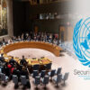 United Nations Security Council meeting around a large circular table with delegates seated; UN emblem on the right.
